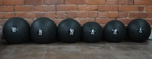 Load image into Gallery viewer, fitness store slam balls in various weights lined up against brick wall
